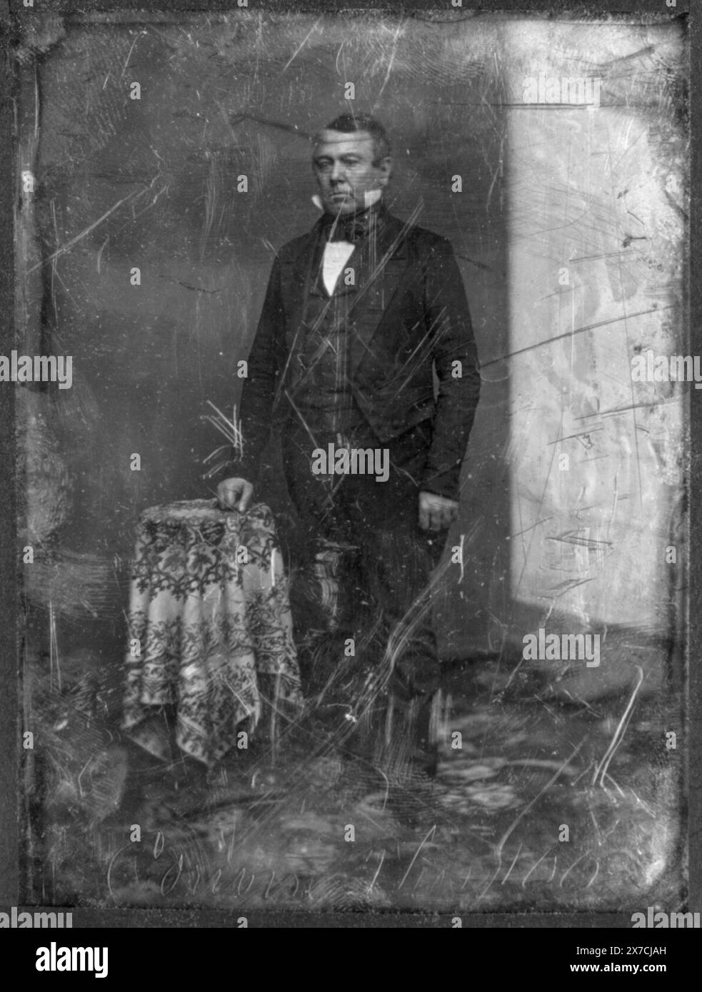 Thomas Corwin, full-length portrait, three-quarters to the left, standing by table with tablecloth, backdrop or reflector screen prominent on left, Scratched on face of plate: 100; Corwin Thos. Scratched on back of plate: Hon. Thos. Corwin (Ohio)., Corners trimmed., Hallmark: [asterisk double paschal lamb], Transfer; U.S. War College; 1920; (DLC/PP-1920:46153)., Forms part of: Daguerreotype collection ,  Produced by Mathew Brady's studio.. Corwin, Thomas,  1794-1865. Stock Photo