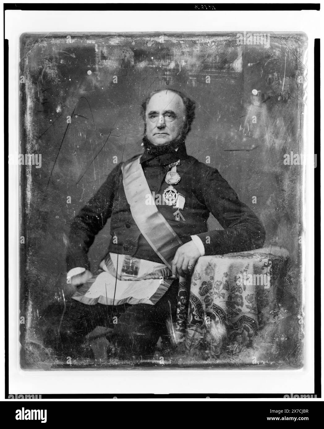 Unidentified man, about 60 years of age, in Masonic regalia, three-quarter length portrait, three-quarters to the left, seated at table with tablecloth, Written on back of plate: 501(X)., Transfer; U.S. War College; 1920; (DLC/PP-1920:46153)., Forms part of: Daguerreotype collection ,  Produced by Mathew Brady's studio.. Fraternal organizations, 1840-1860. Stock Photo