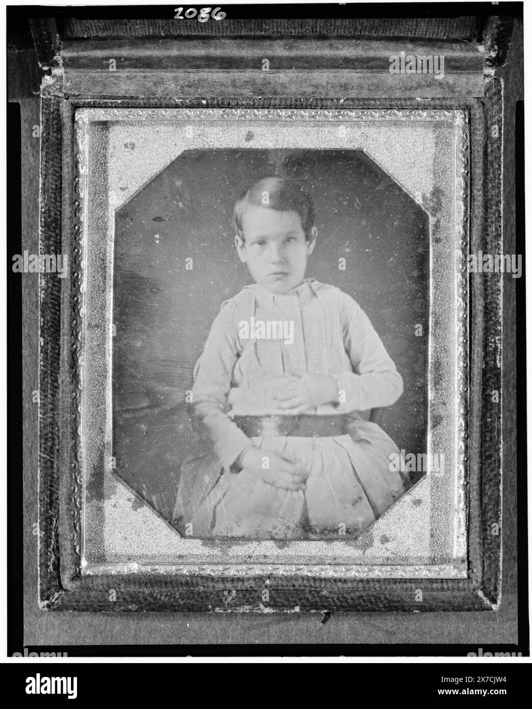 Unidentified boy, three-quarter length portrait, seated, Photographer unidentified., Hallmark: [asterisk double paschal lamb] 30., Case: plain brown leather with decorative motif in each corner., Gift; Charles W. Millard; 1976; (DLC/PP-1976:096)., Forms part of: Daguerreotype collection , . Stock Photo