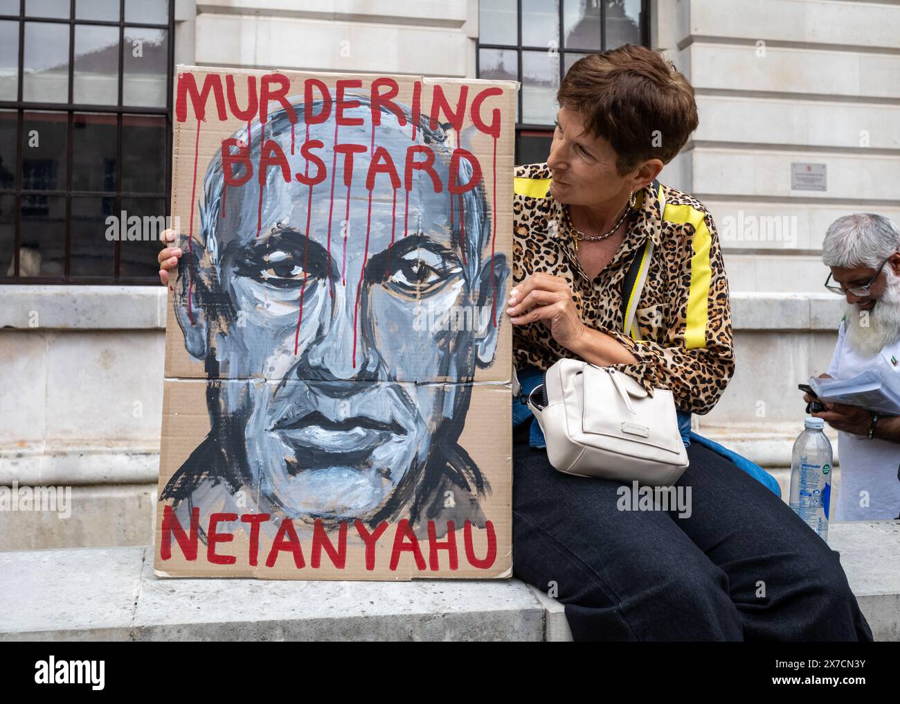 London, UK. 18 May 2024: A Jewish woman holds a placard accusing Israel PM Netanyahu of being a murderer at the Nakba 76 March for Palestine against I Stock Photo