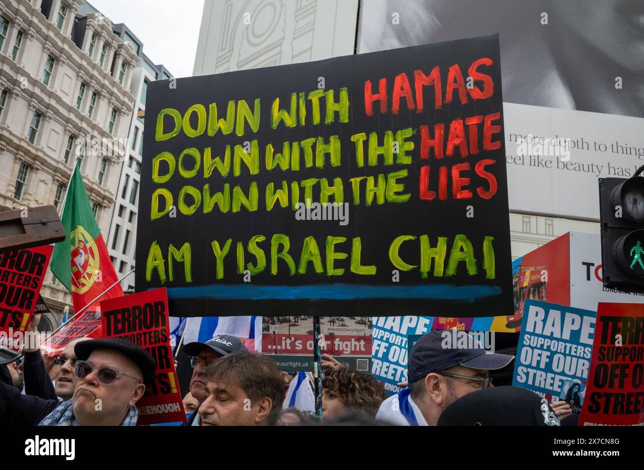 London, UK. 18 May 2024: Pro-Israel counter demonstrators hold placards at Piccadilly Circus as they shout at and taunt people marching for peace in P Stock Photo