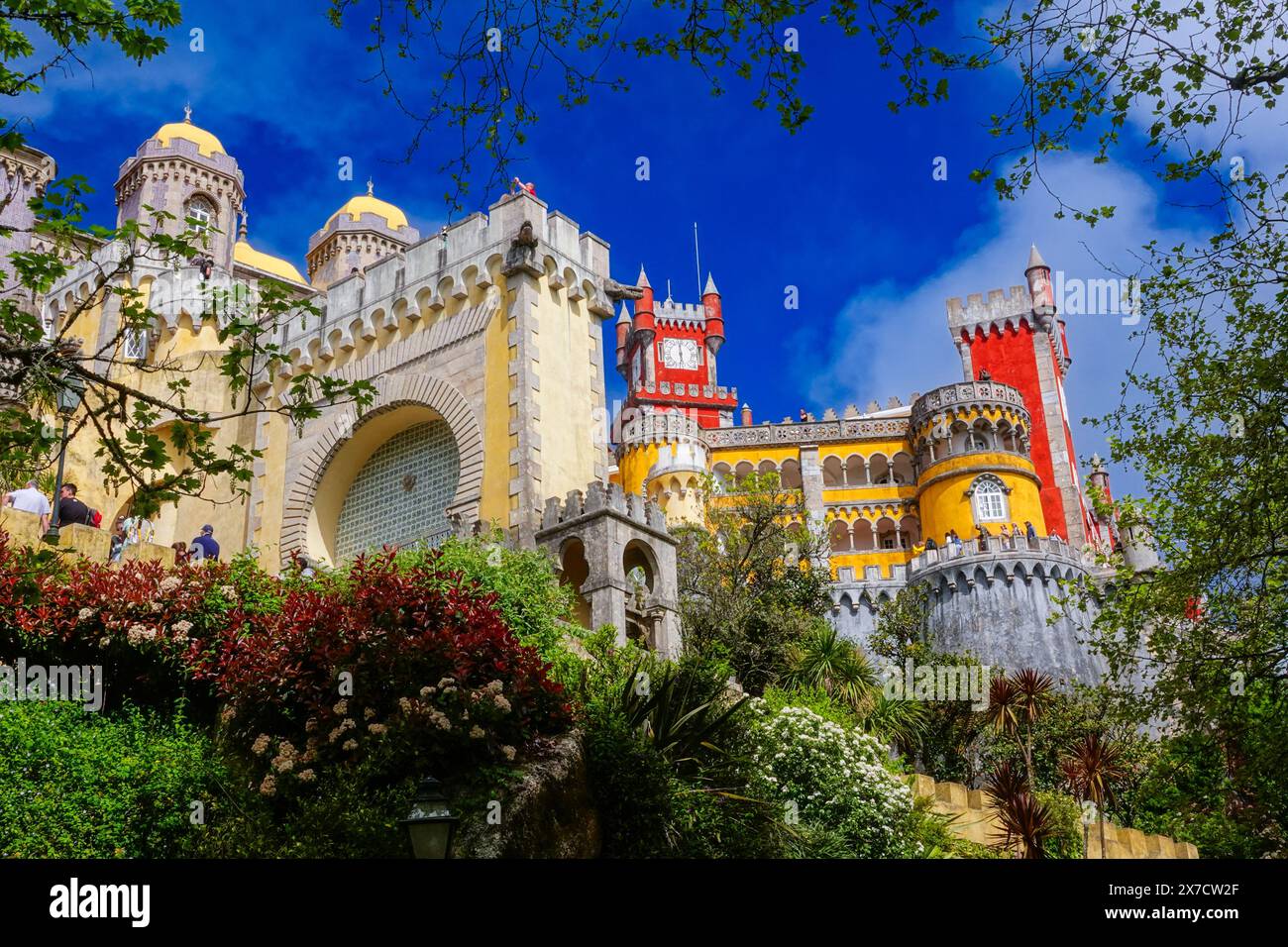 The Pena Palace or Palácio da Pena historic palace castle viewed from the Coach Yard in Sintra, Portugal. The fairytale castle palace is considered one of the finest examples of 19th century Portuguese Romanticism architecture in the world. Stock Photo