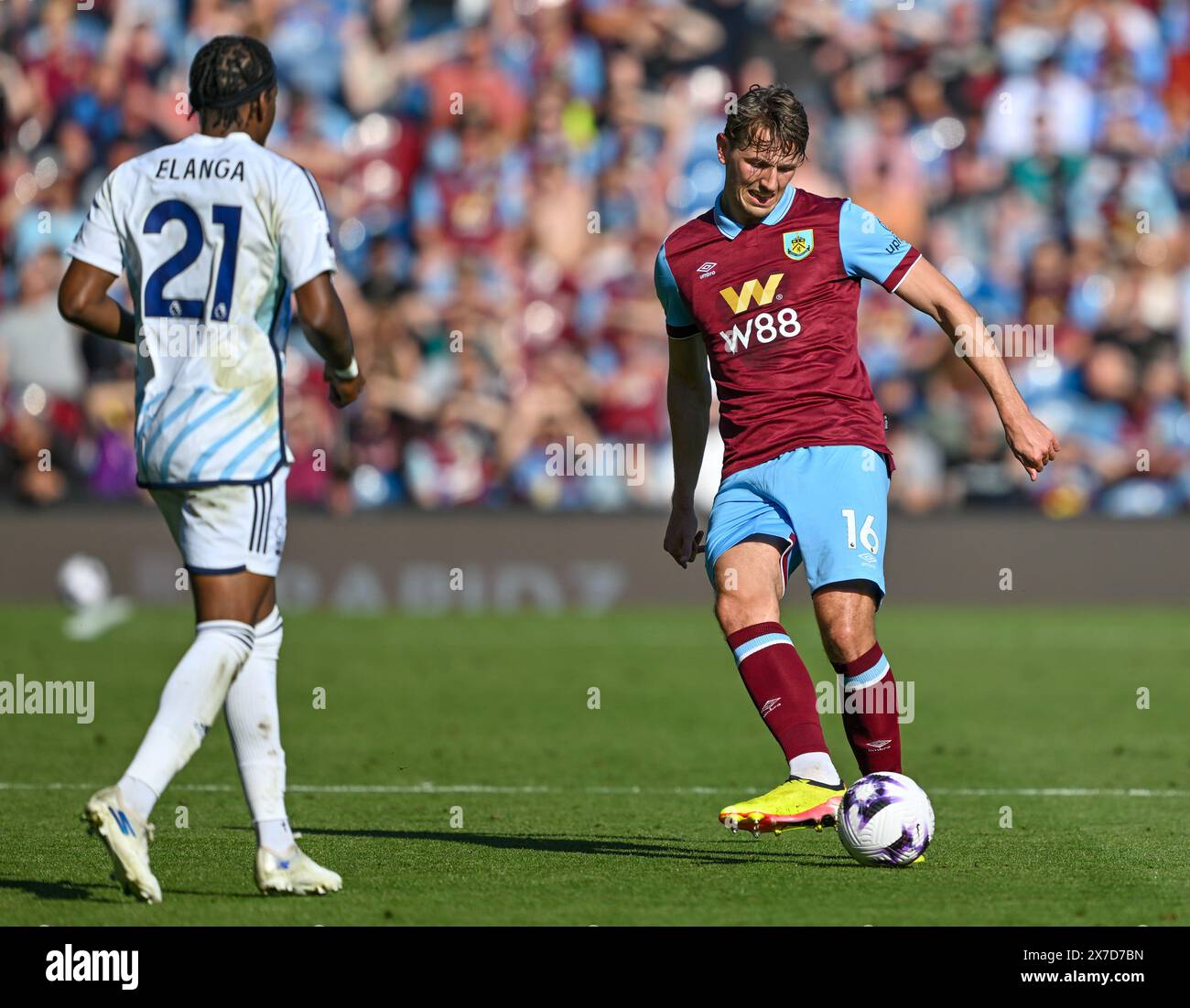 Turf Moor, Burnley, Lancashire, UK. 19th May, 2024. Premier League Football, Burnley versus Nottingham Forest; Sander Berge of Burnley passes the ball under pressure from Anthony Elanga of Nottingham Forest Credit: Action Plus Sports/Alamy Live News Stock Photo
