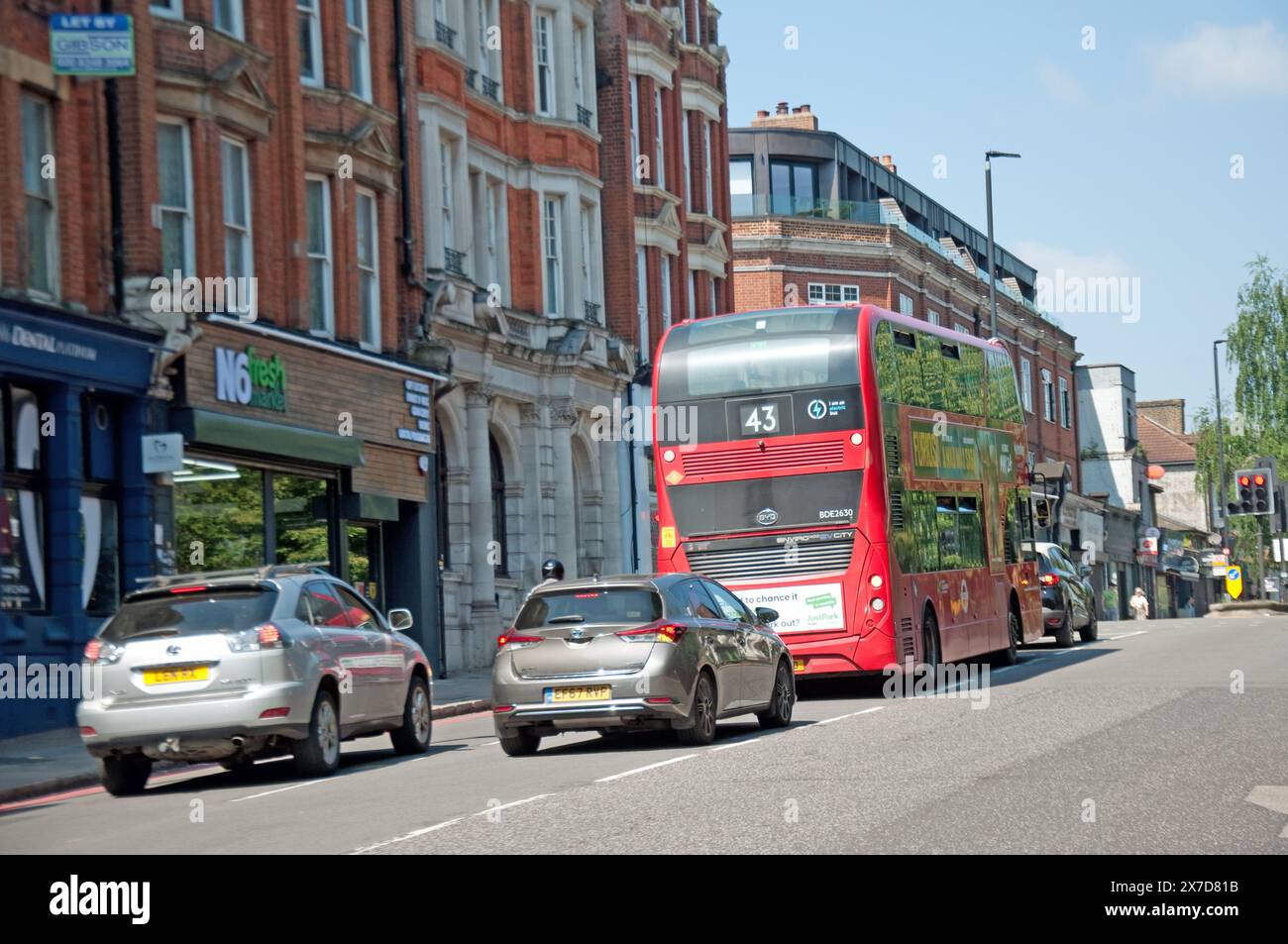 Street Scene, Highgate High Street, Highgate, London, UK - traffic; shops; bus; London bus; double-decker bus; Highgate is a suburban area of London. Stock Photo