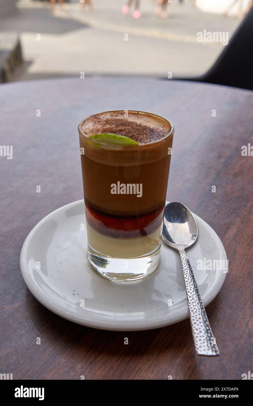 Canarian coffee called Barraquito on a table on the terrace of a bar. Stock Photo