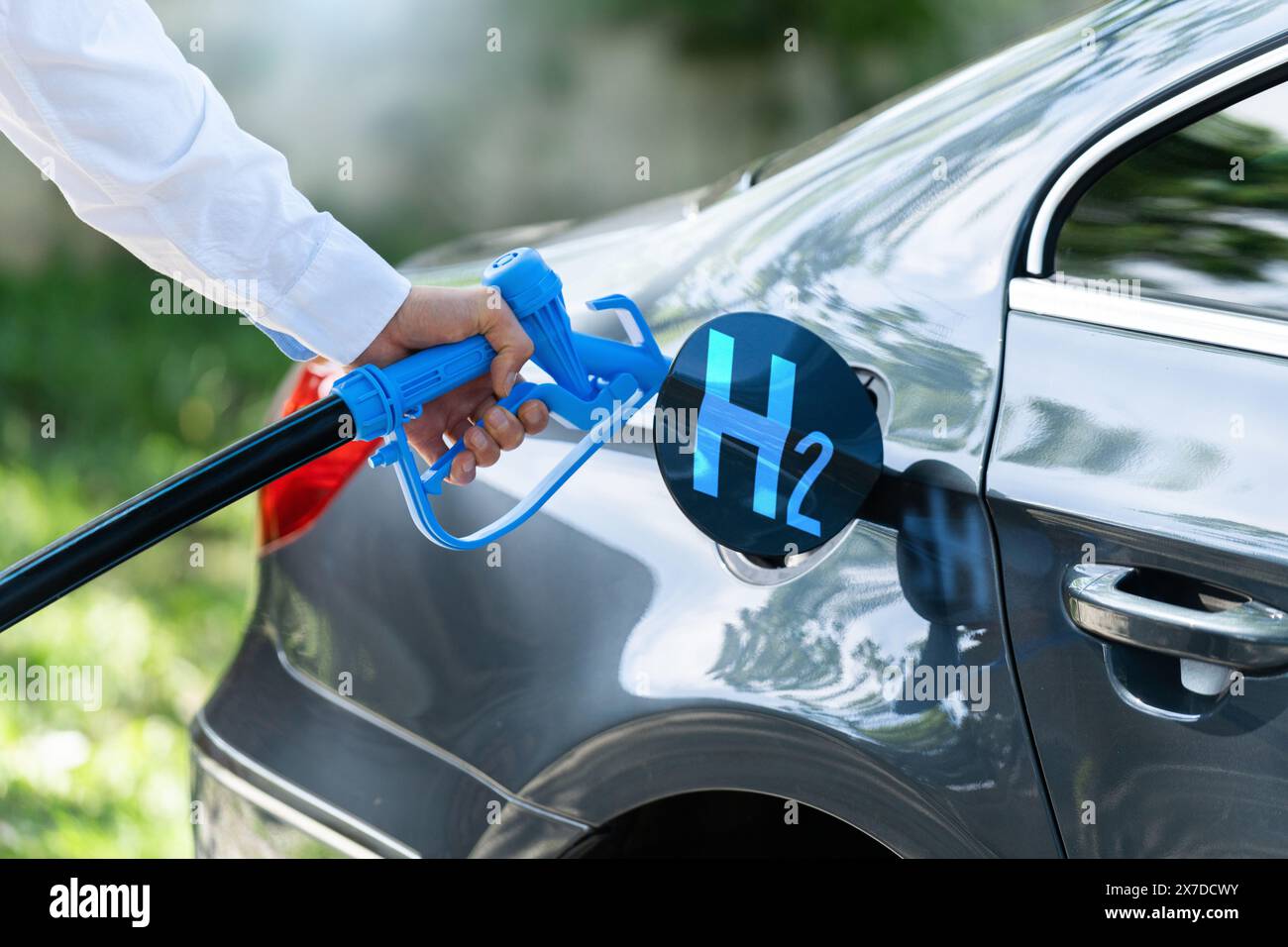 Man holds a hydrogen fueling nozzle. Refueling car with hydrogen fuel. Concept.. Stock Photo