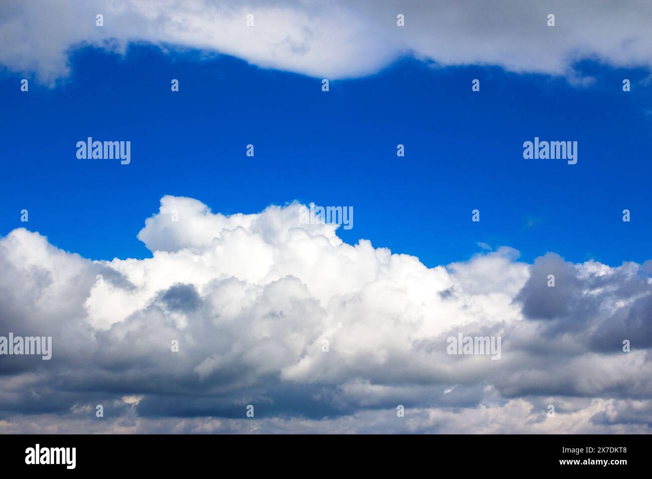 grey clouds on a blue sky. calm nature background. weather change before the rain Stock Photo