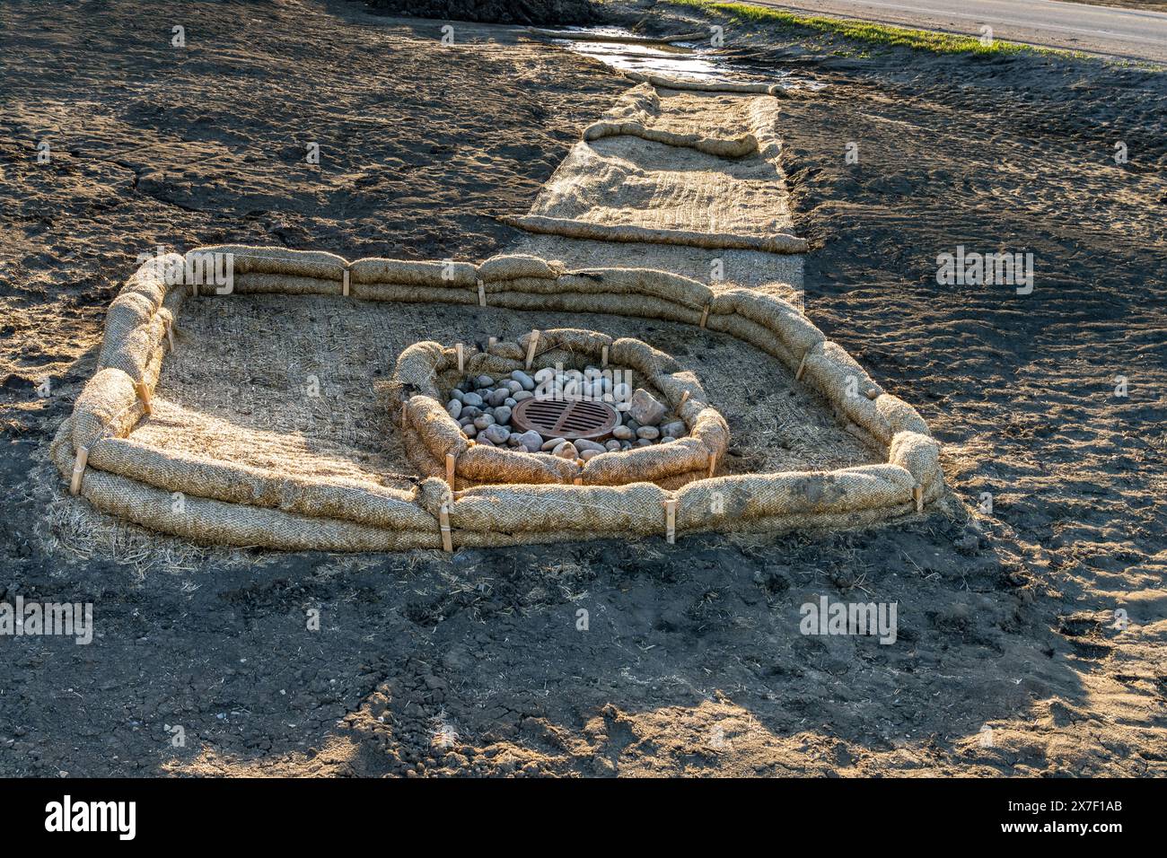 Biodegradable erosion control straw sock and straw blanket guard at run
