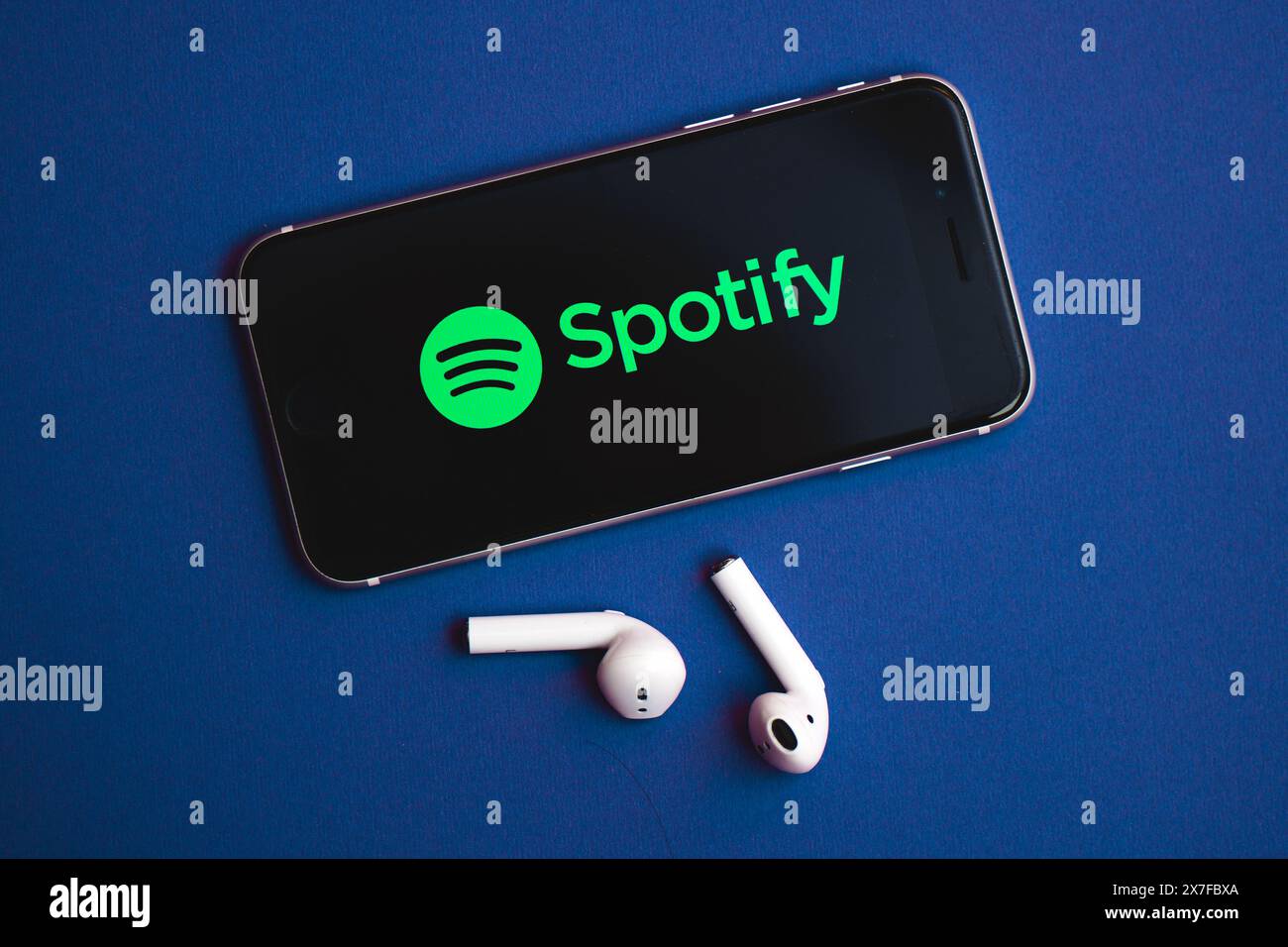 San Pellegrino terme, Italy - May 20, 2024: Smart-phone with Spotify logo and headphones Stock Photo