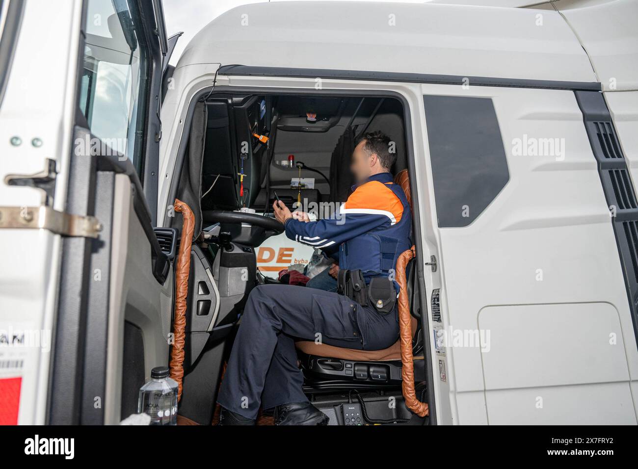 Antwerp, Belgium. 20th May, 2024. A police officer inspects a truck as the Antwerp Police Zone, the Federal Police, the Social Intelligence and Investigation Service SIOD and the European Labor Authority ELA are organizing a large-scale heavy transport inspection action under the leadership of the labor auditor, with a focus on the employment conditions of truck drivers, in Antwerp, Monday 20 May 2024. BELGA PHOTO JONAS ROOSENS Credit: Belga News Agency/Alamy Live News Stock Photo