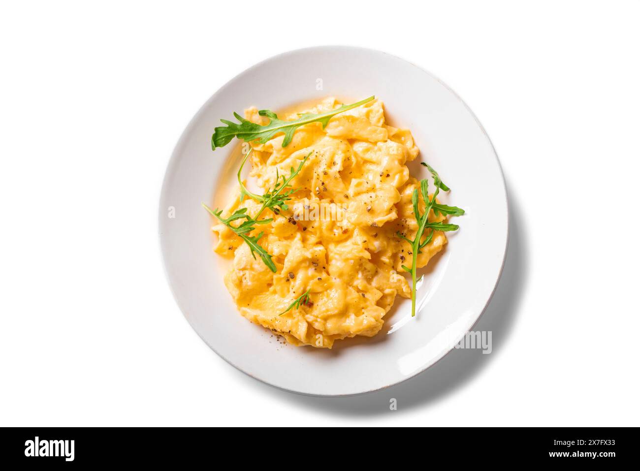 Scrambled eggs with arugula on white plate isolated on white background ...