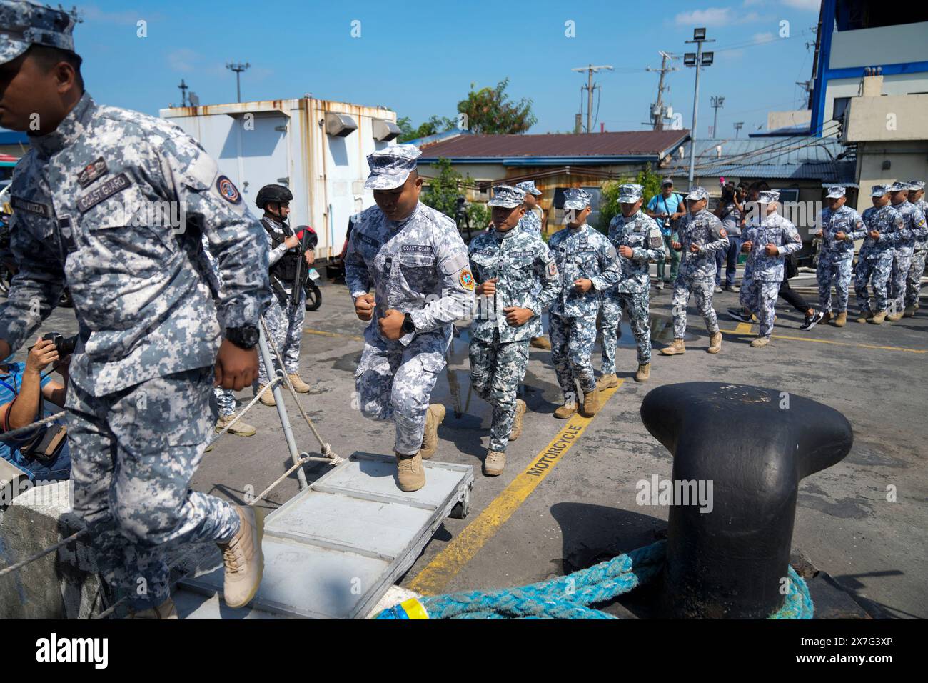 Philippine Coast Guard personnel board a ship during their send-off ...