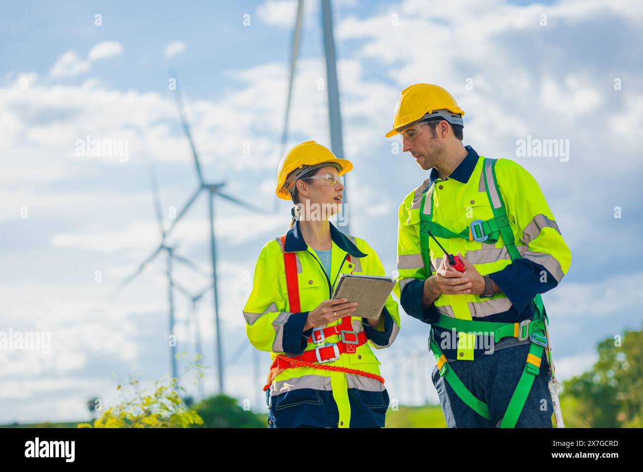 professional engineers working service maintenance wind turbines. Clean energy for future. Alternative eco natural power generator worker people conce Stock Photo
