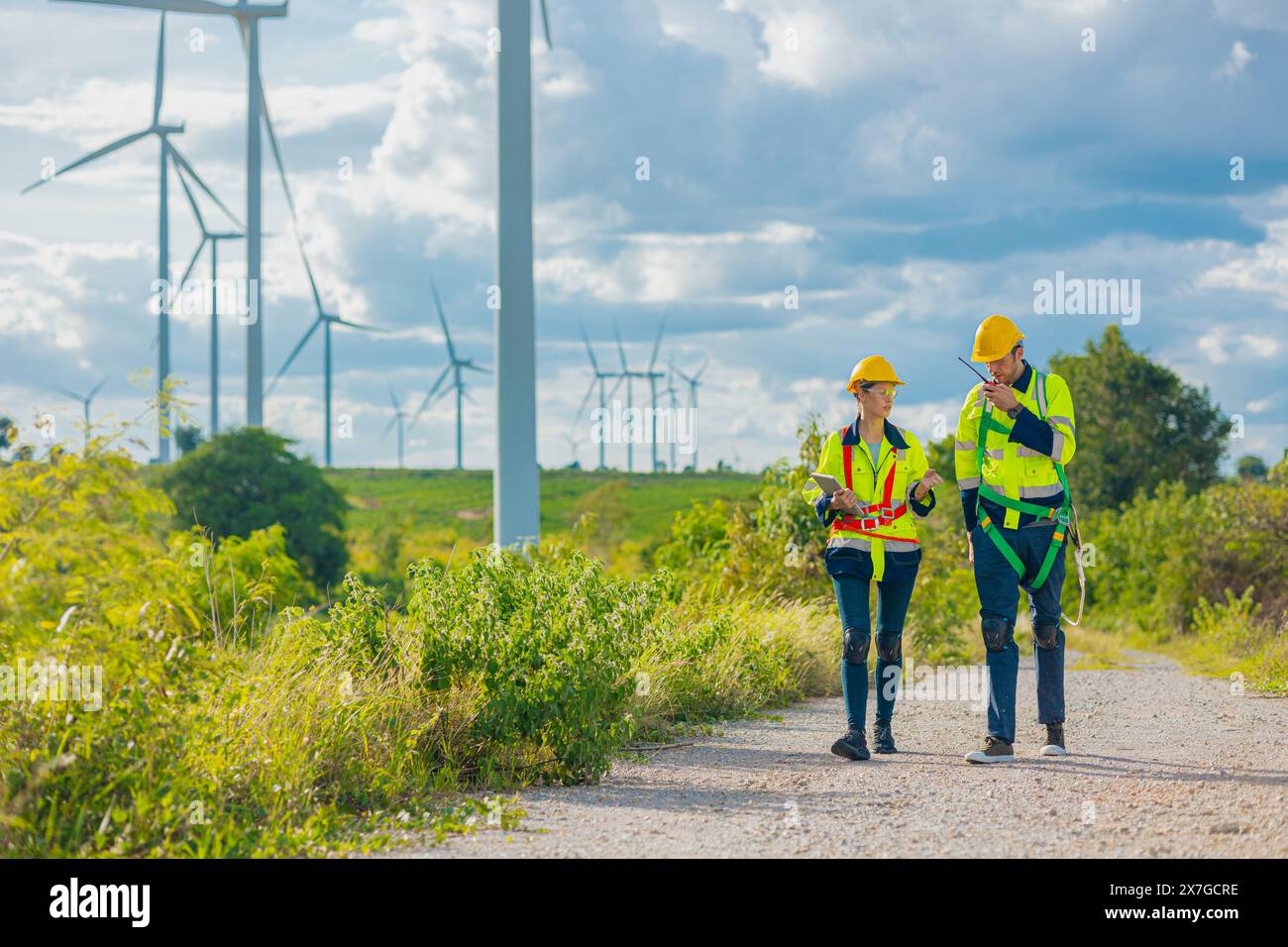 professional engineers working service maintenance wind turbines. Clean energy for future. Alternative eco natural power generator worker people conce Stock Photo