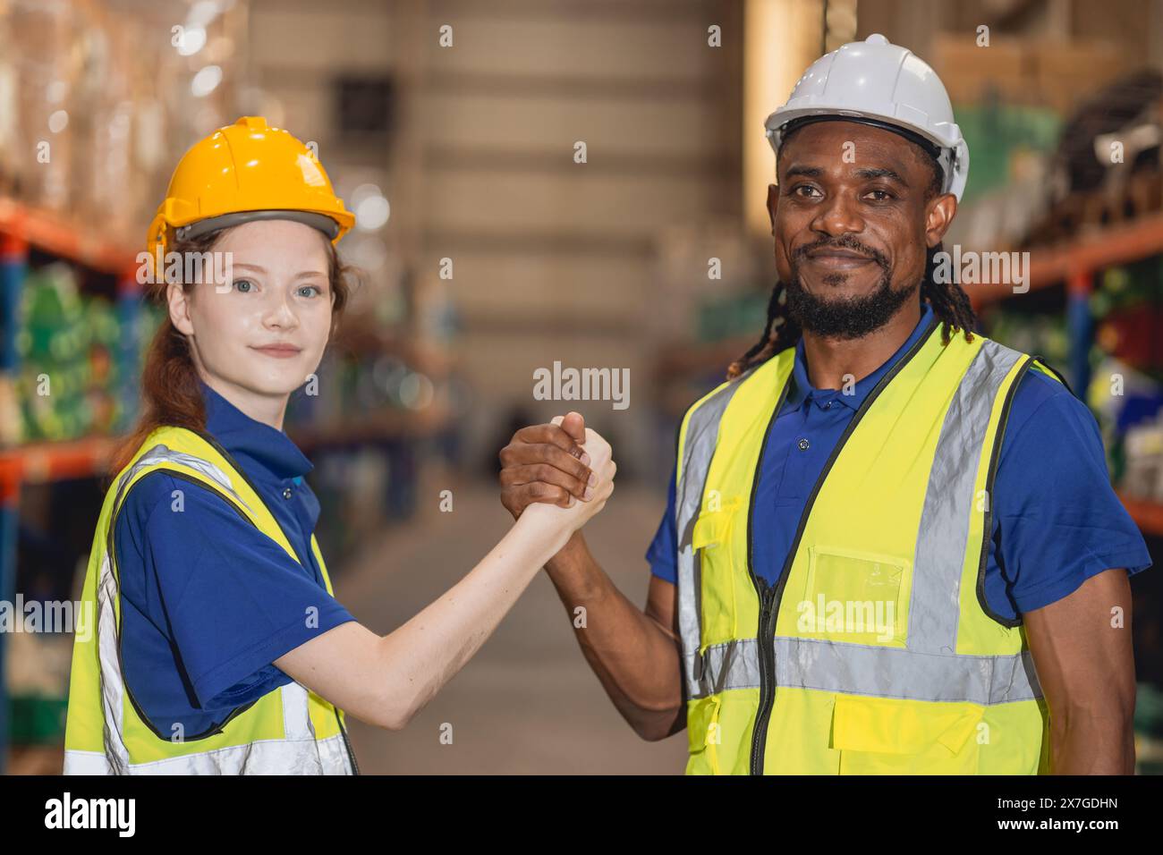 Worker in cargo warehouse teamwork support trainee young women with African foreman help together Stock Photo