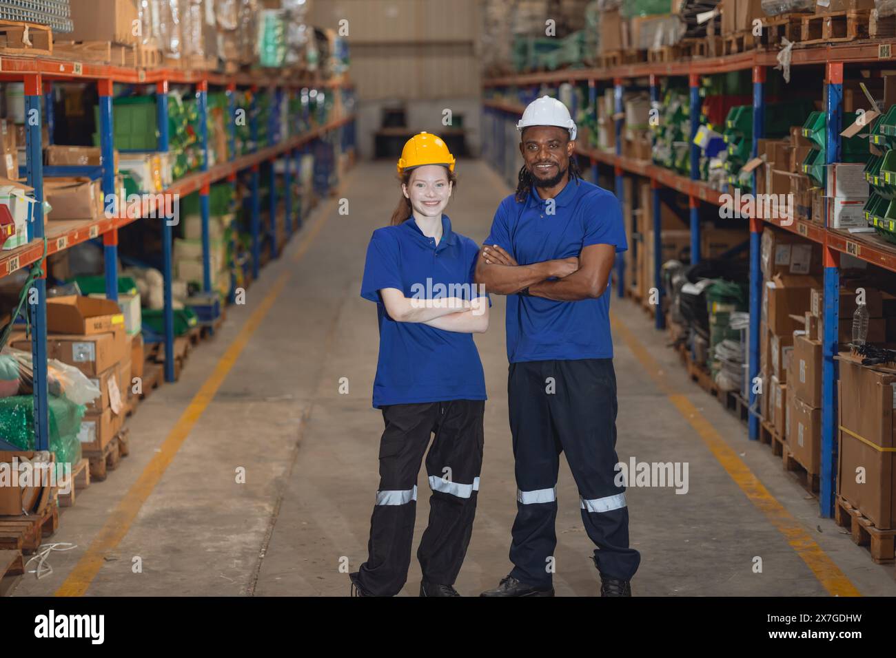 Worker in cargo warehouse teamwork support trainee young women with African foreman help together Stock Photo