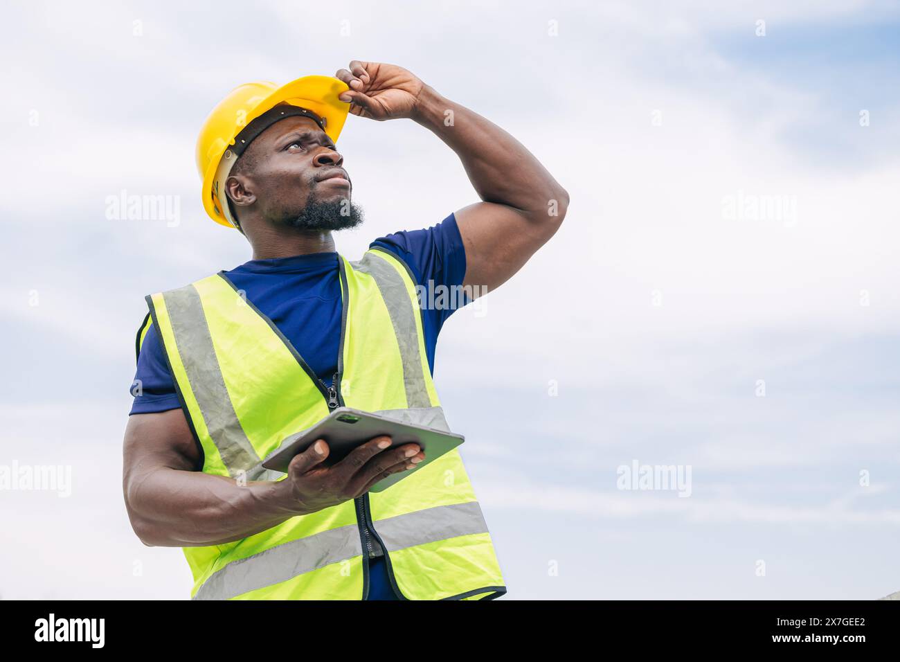 Portrait African black smart engineer worker foreman supervisor standing looking high outdoor Stock Photo