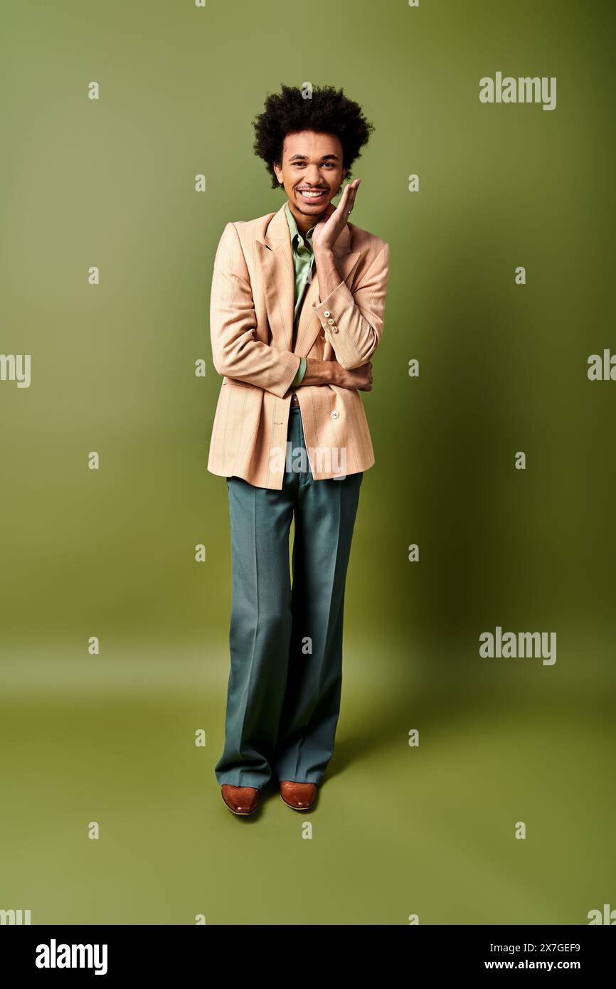 A stylish young African American man in a suit stands confidently ...