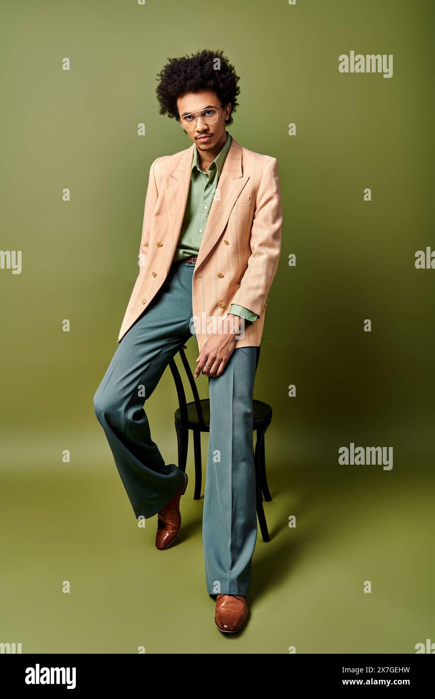 A stylish young African American man in a suit and sunglasses ...