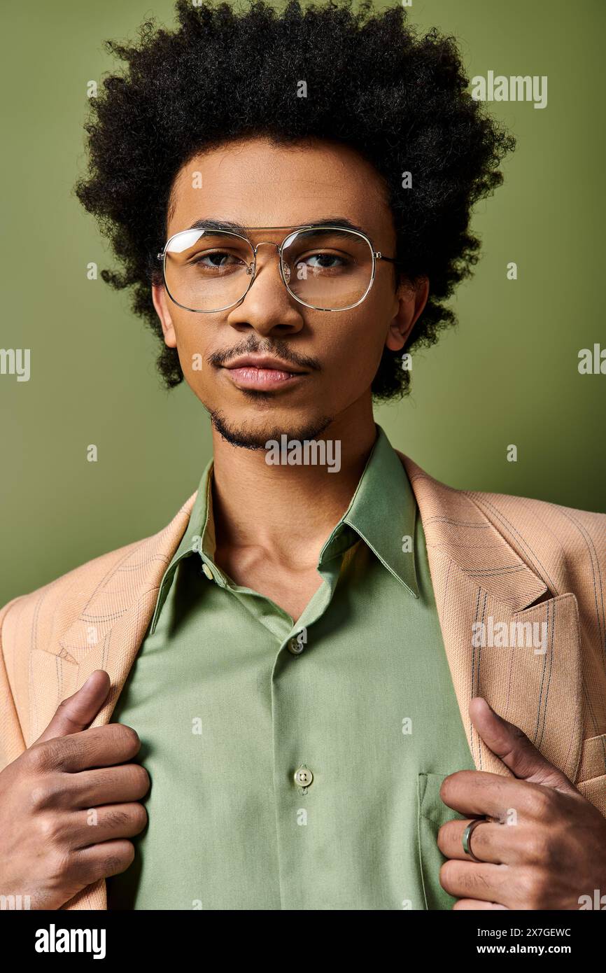 A stylish young African American man with curly hair wearing trendy ...