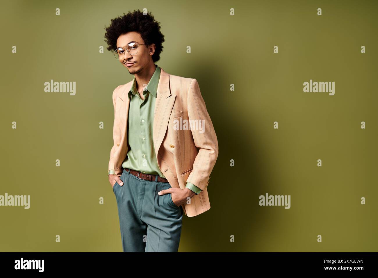 A young African American man, stylishly dressed, stands confidently in ...