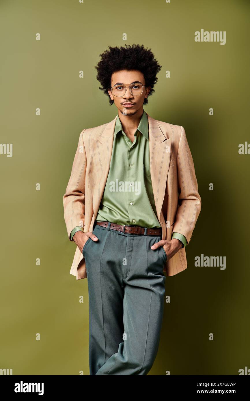 A stylish young curly African American man in a suit and tie standing ...