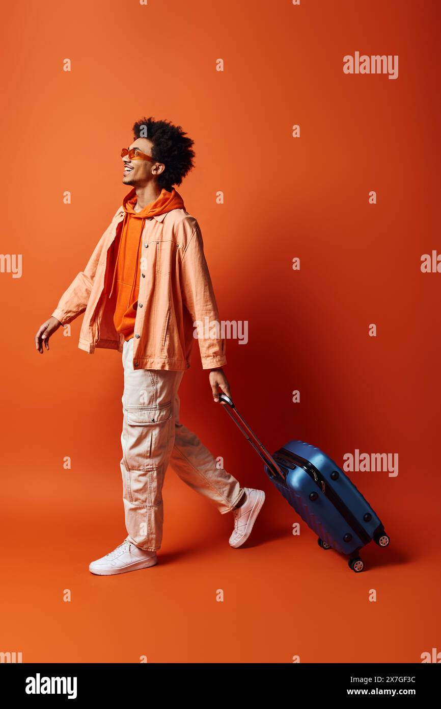 A stylish young African American man with curly hair and trendy attire ...