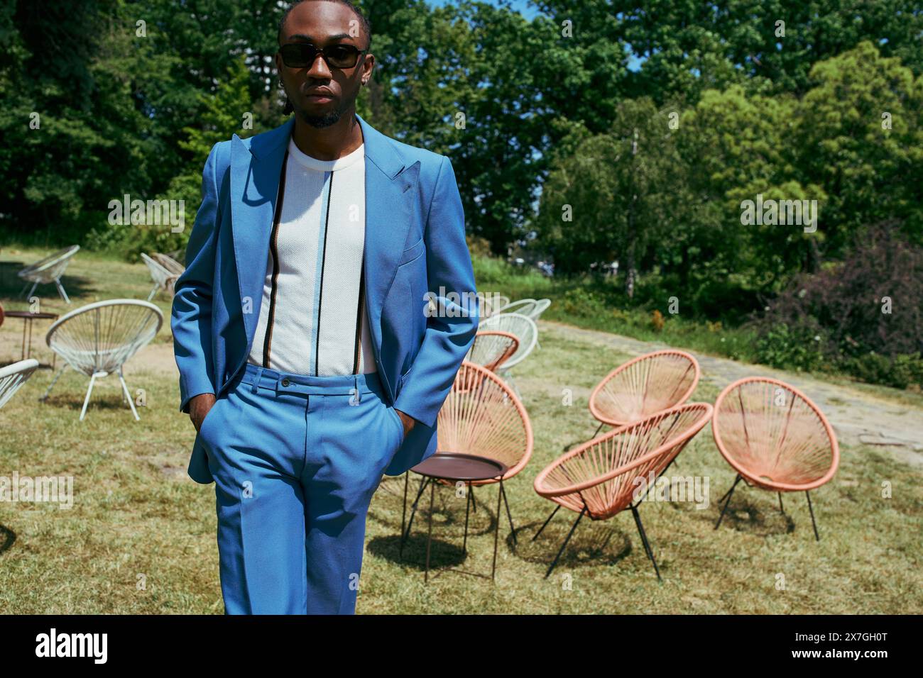 Handsome African American man in a blue suit standing confidently in a ...