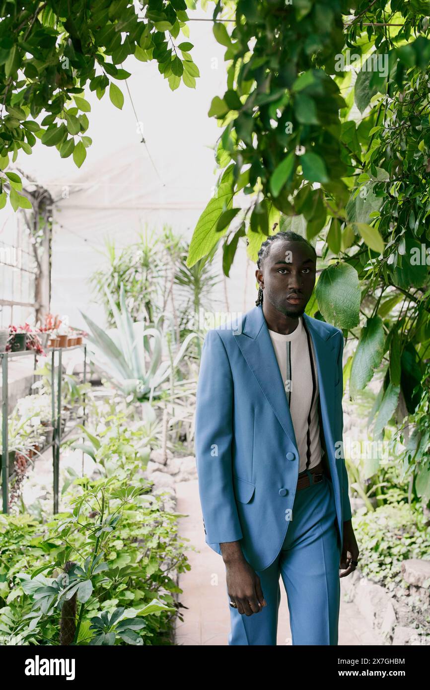 Handsome African American man in a blue suit stands amidst a vivid ...