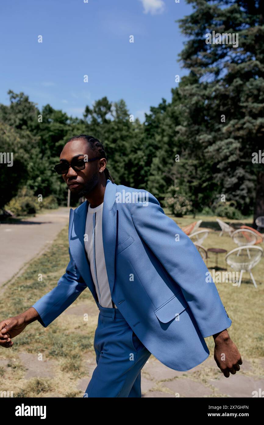 Stylish African American man in blue suit walks confidently along ...