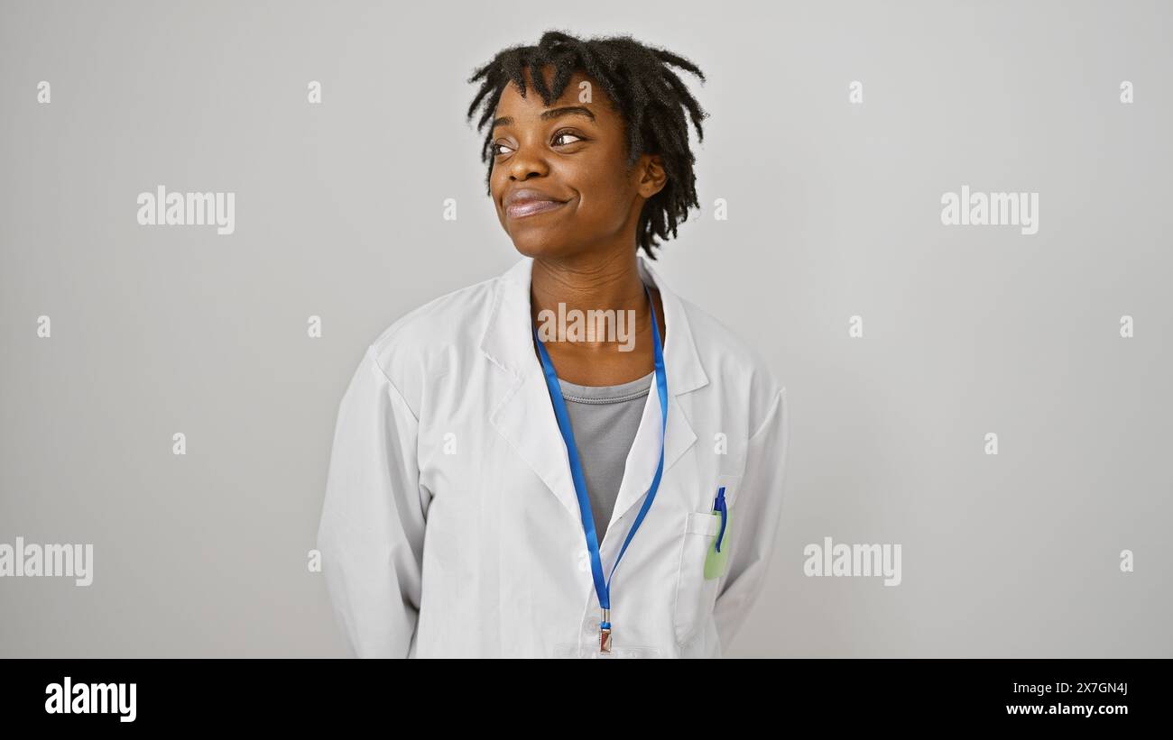 A contemplative young black woman with dreadlocks wearing a lab coat ...
