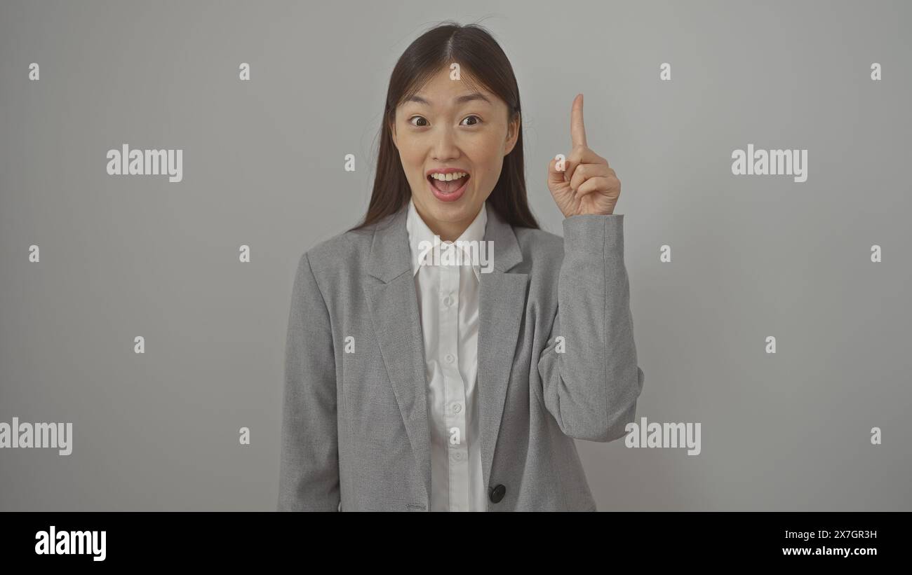 Asian woman pointing upwards hi-res stock photography and images - Alamy