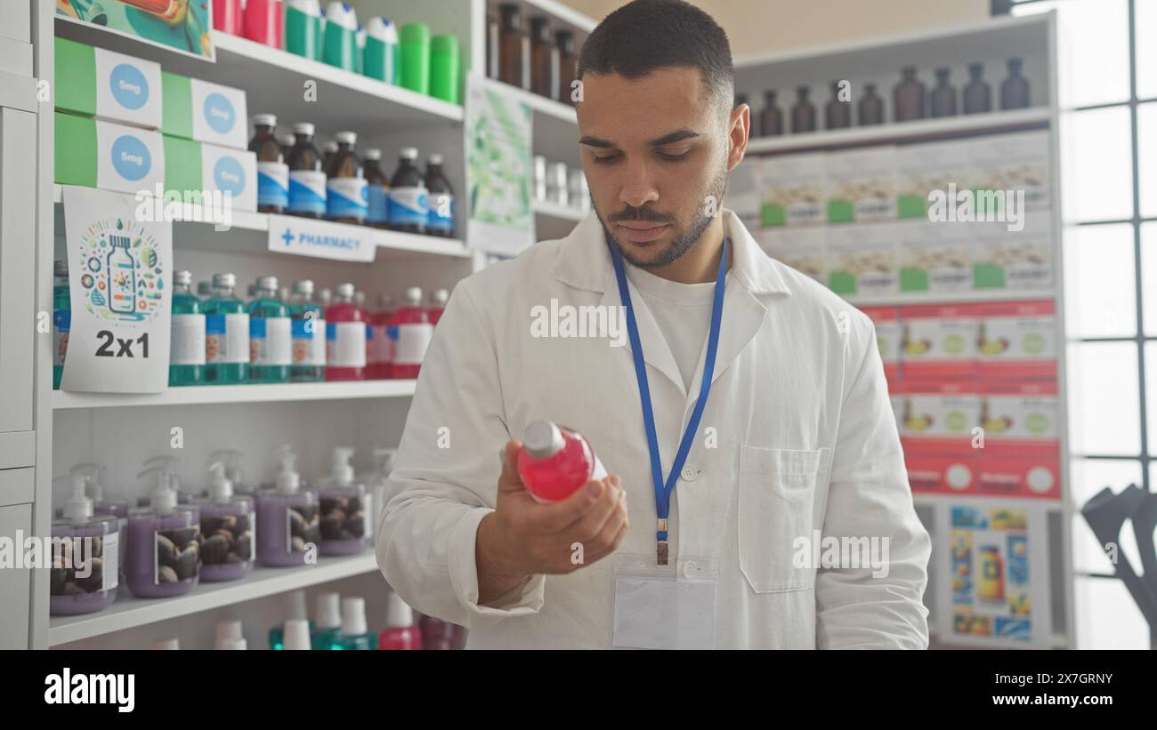 Hispanic man in white lab coat examining product at pharmacy with shelves of medication behind him Stock Photo