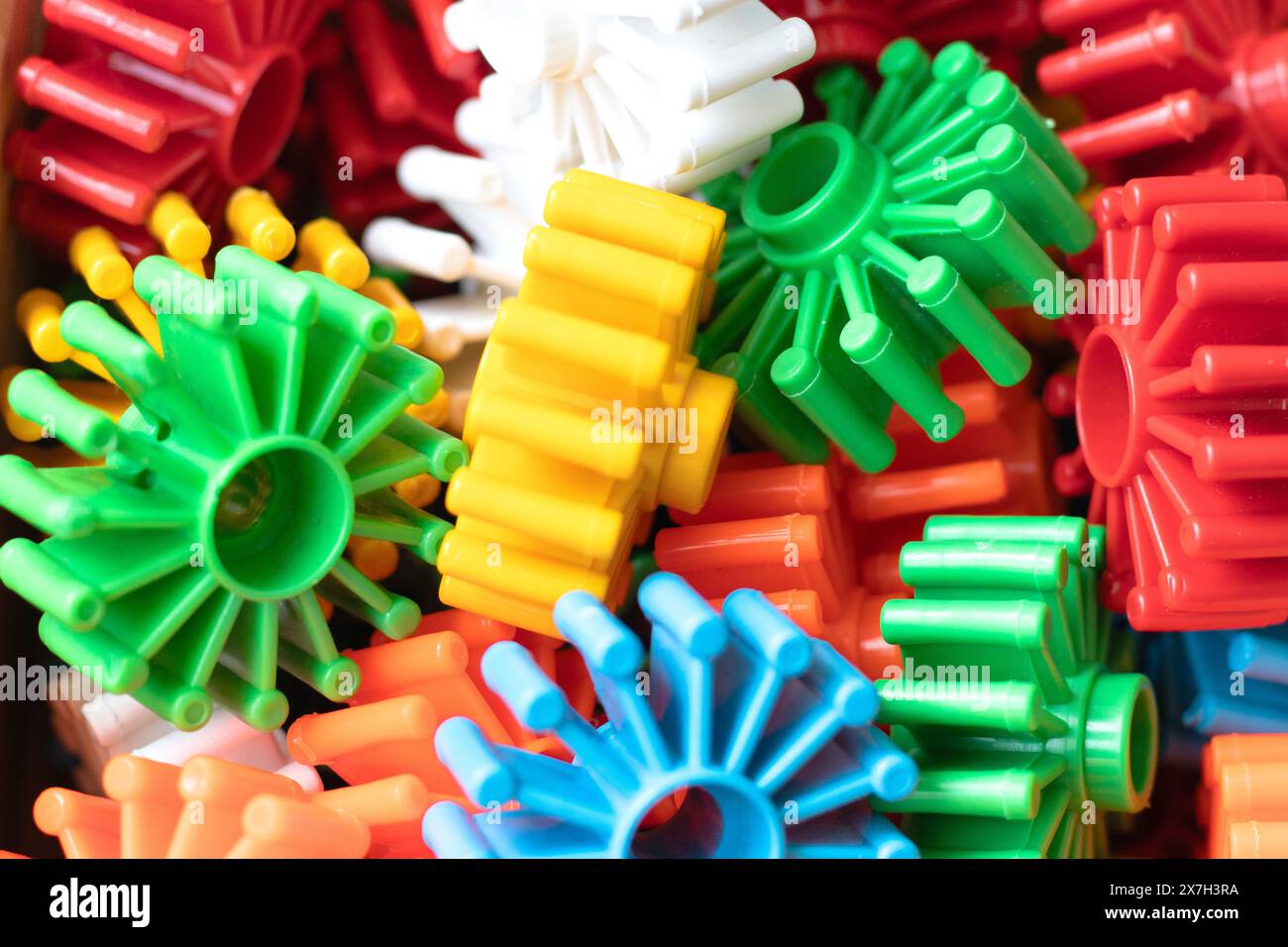 Colorful plastic toy gear. Top view. Building construction toys idea concept for kids. Above. Horizontal photo. No people, nobody. Pattern. Wallpaper. Stock Photo