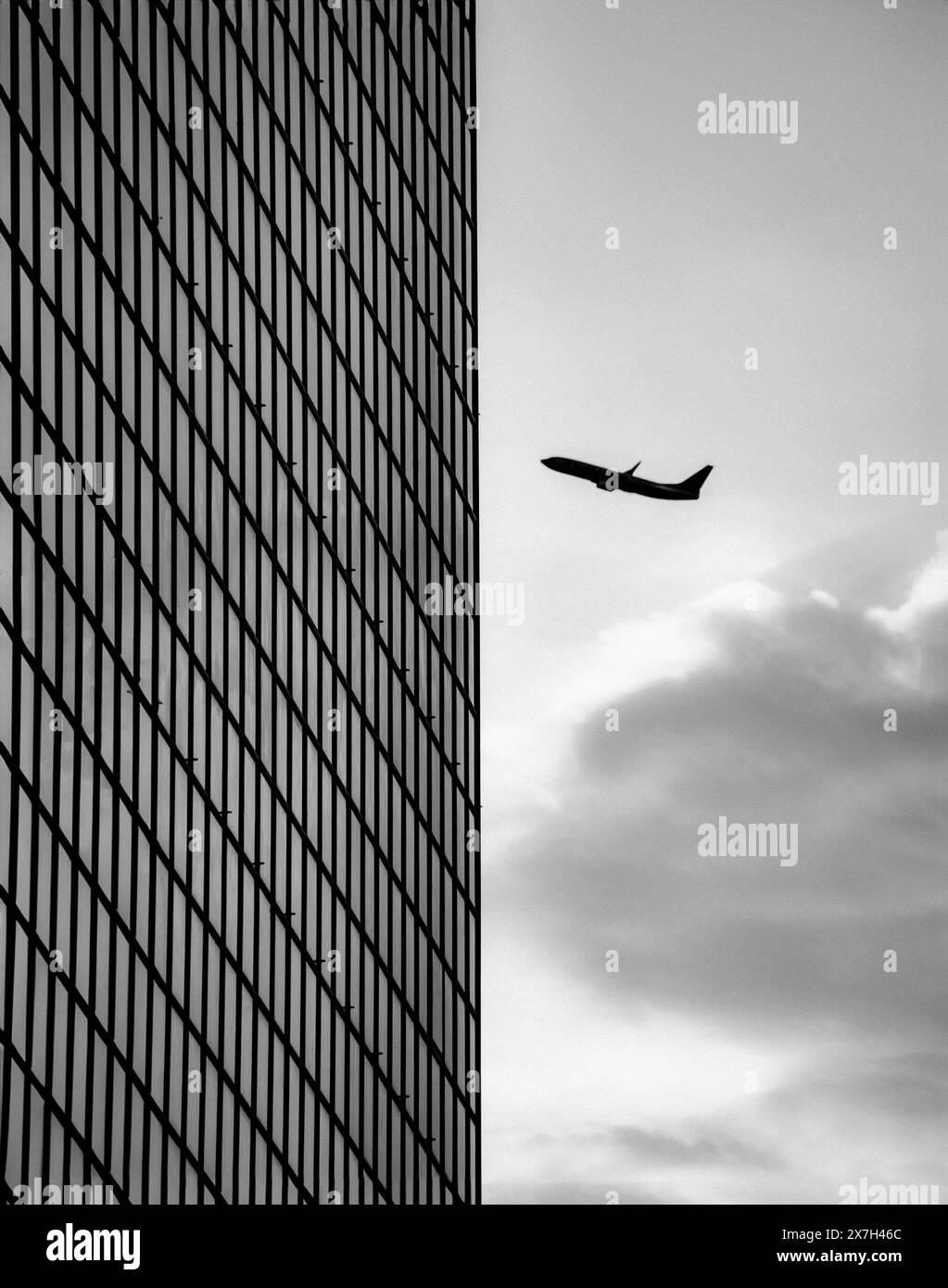 Skyscraper and airliner in landscape Stock Photo