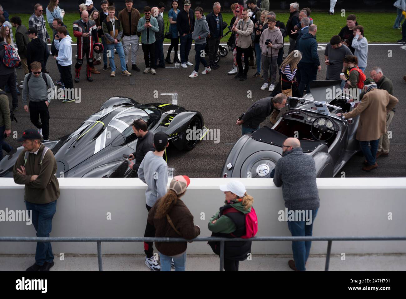 People crowding round an Aston Martin Valkyrie Hypercar at the 100th Breakfast Club at Goodwood motor racing circuit, Chichester,West Sussex,UK Stock Photo