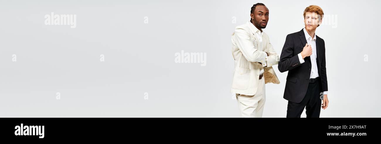 Two multicultural men in elegant attire stand together. Stock Photo