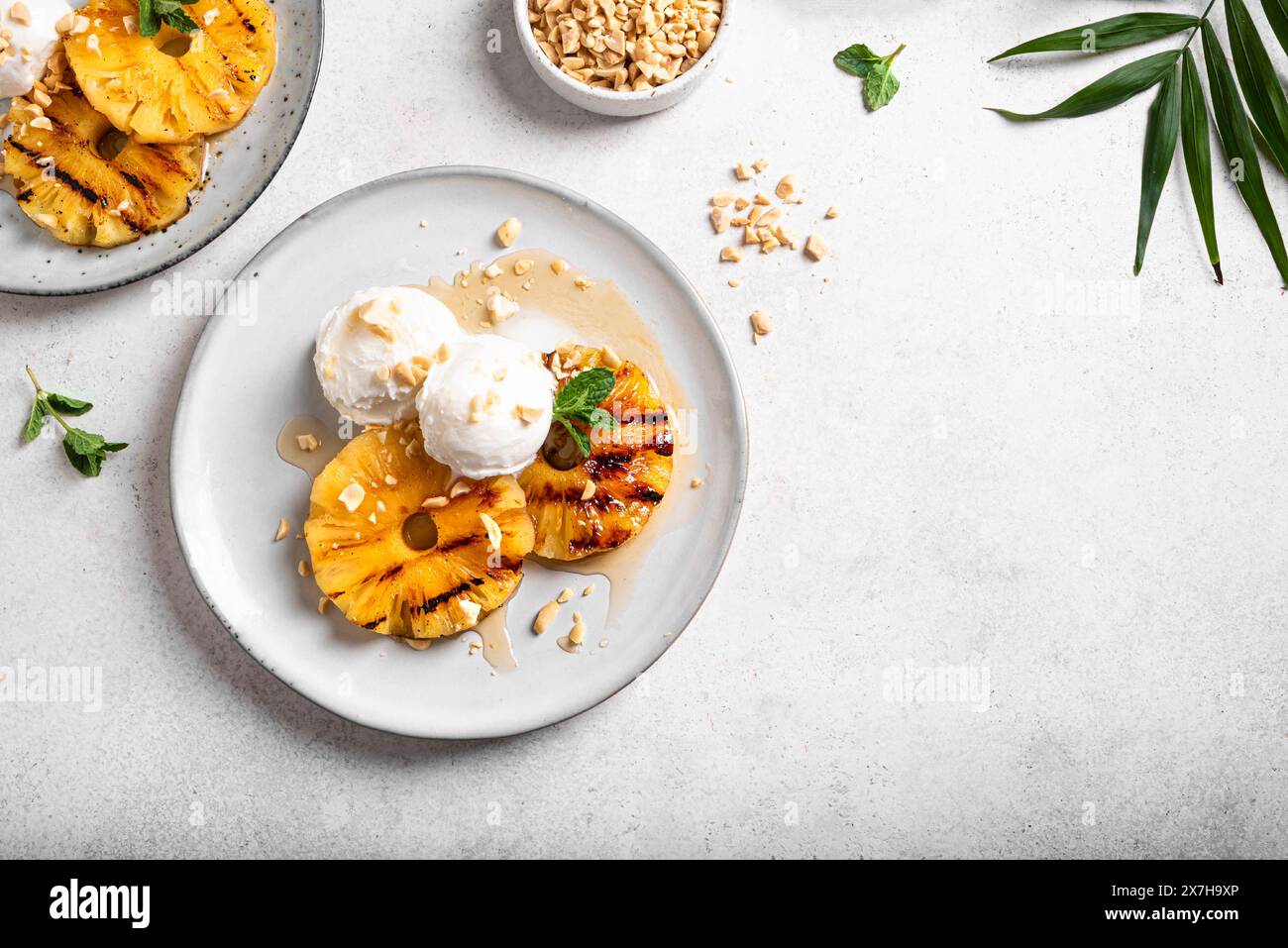 Grilled pineapples with rum honey glaze, coconut icecream and grated