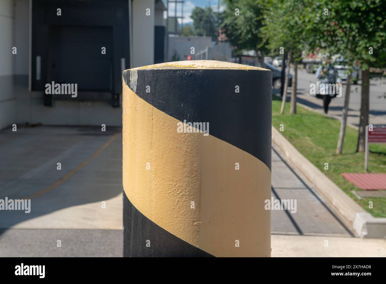 removable anti-breakout pole for windows or to restrict passage to authorized vehicles only. high visibility colors to signal presence. Stock Photo