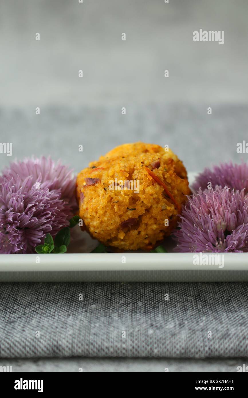 Couscous-Feta Balls with Chive Blossoms on Neutral Grey Background Stock Photo