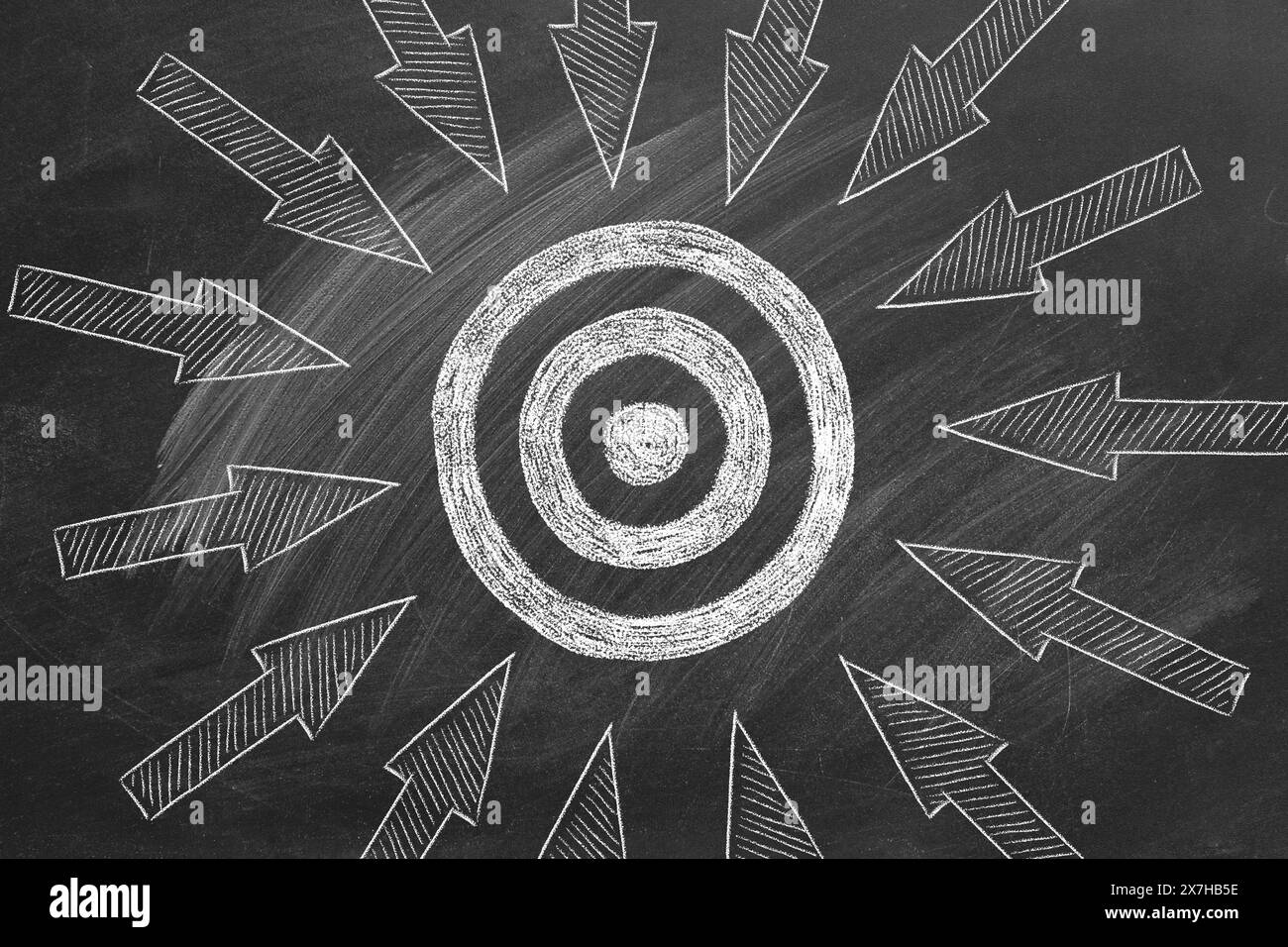 A blackboard with a target at the center, with many arrows drawn, trying to reach the target. Competition concept, business strategy concept. Chalk dr Stock Photo