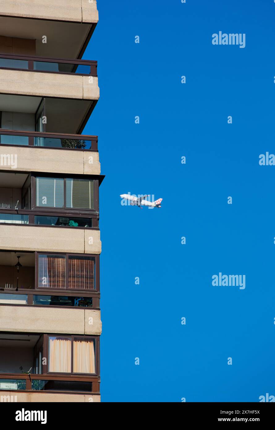 Skyscraper and airliner in landscape Stock Photo - Alamy