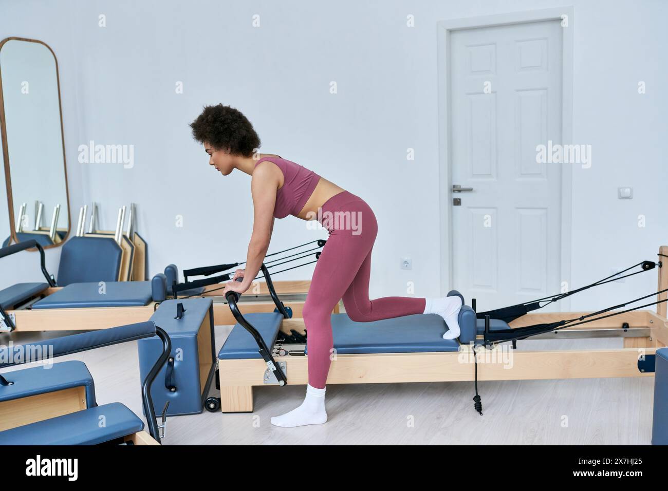 Pink Roweing Machine Focused woman exercises on rowing hi-res stock photography and images ...