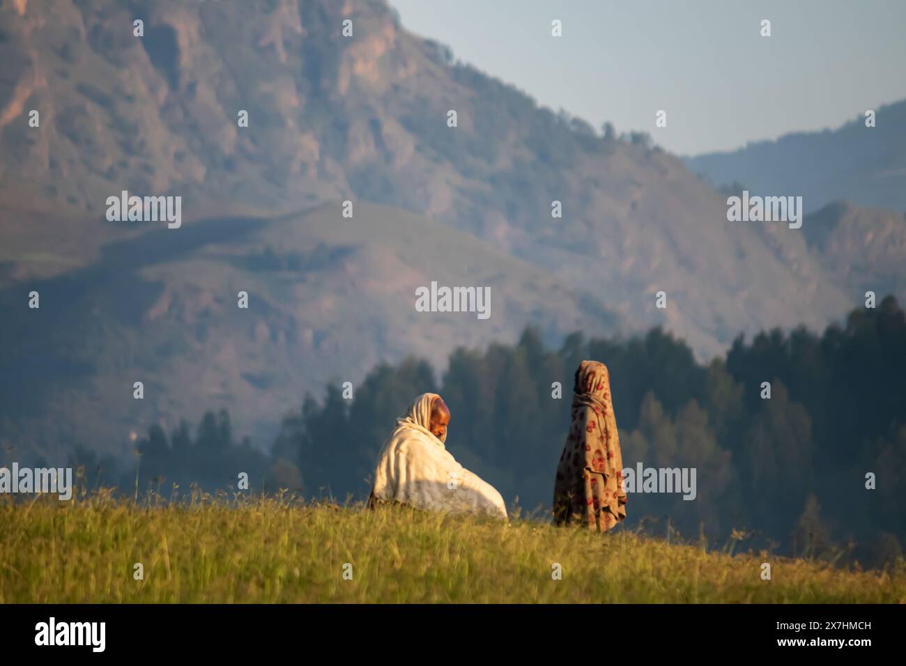 Portrait of traditionally dressed Ethiopian, in remote country side village, with beautiful view on the powerful mountains landscape in background Stock Photo