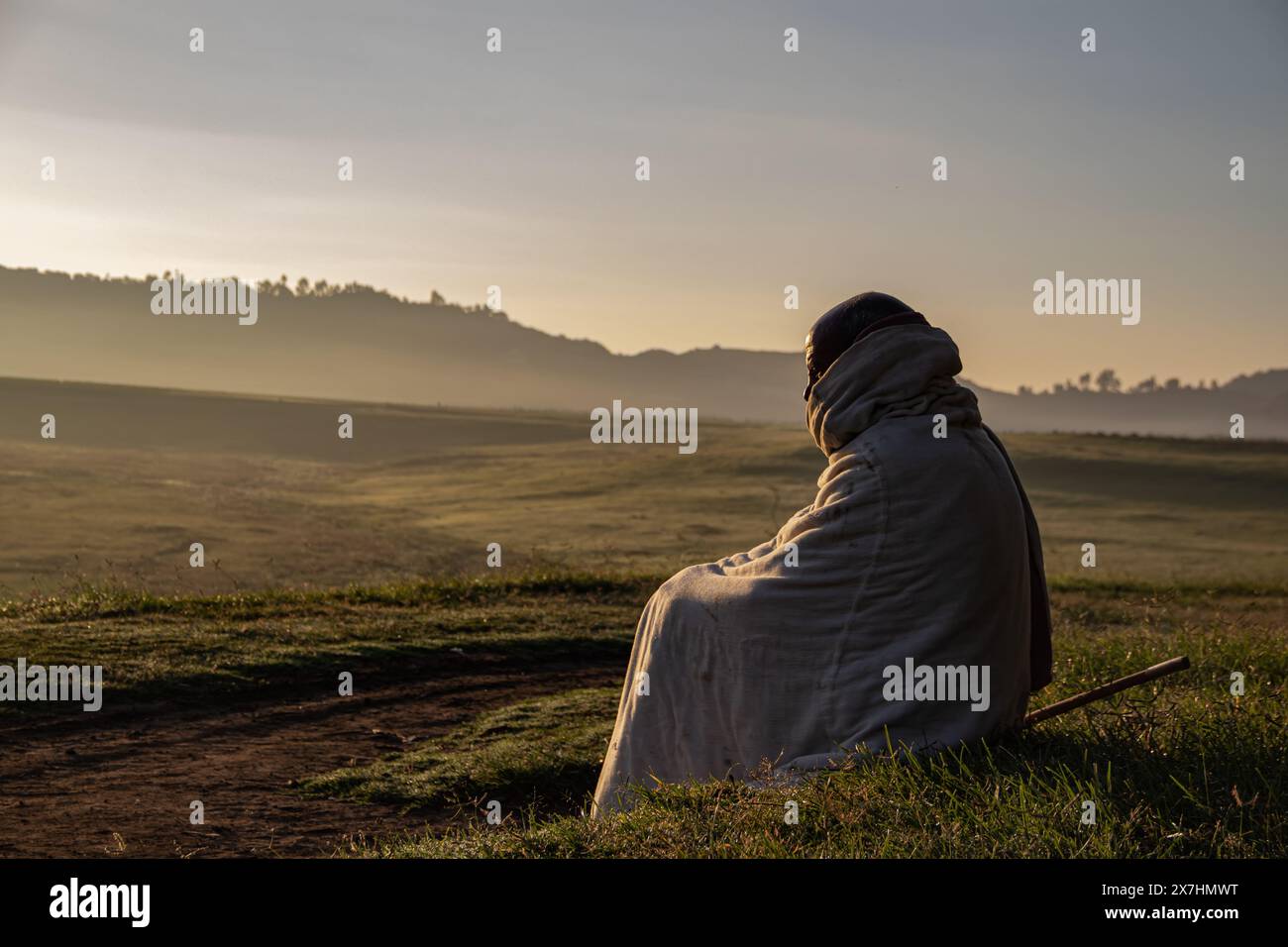 Portrait of traditionally dressed Ethiopian, in remote country side village, with beautiful view on the powerful mountains landscape in background Stock Photo