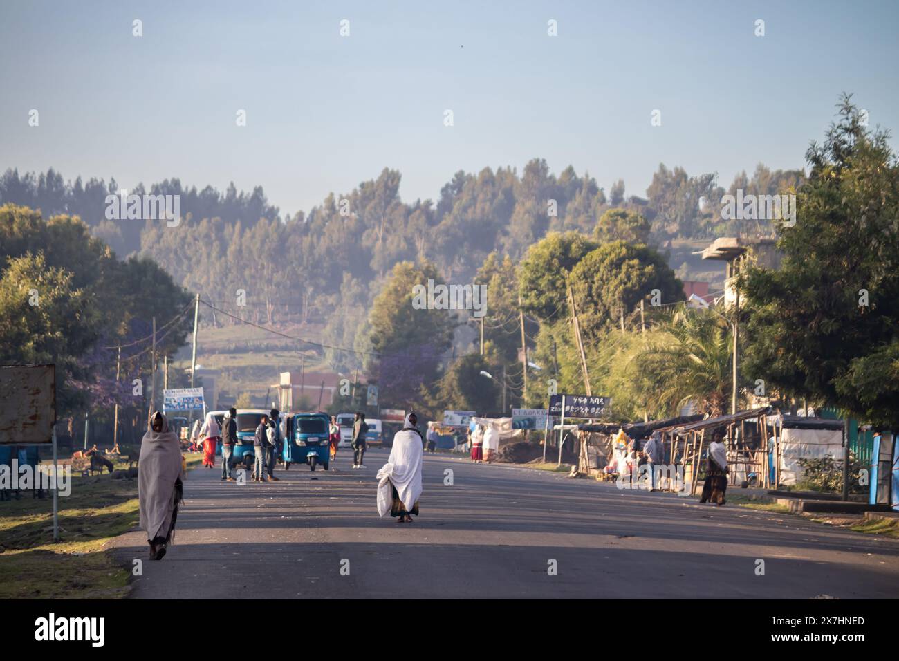 Streets of Korem in Ethiopia, with colorfully traditionally dressed local population walking in local market, street vendors, in the morning hours Stock Photo