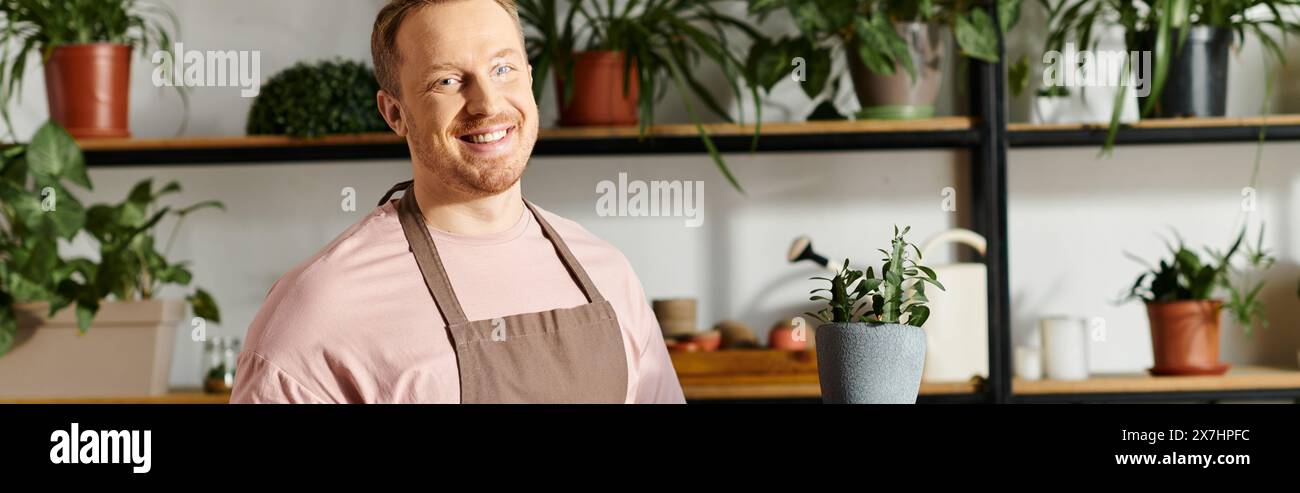 A man in an apron tends to a shelf of potted plants in a small business shop, embodying the essence of owning a florist. Stock Photo