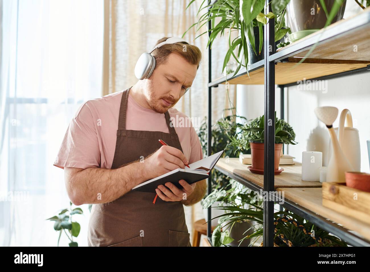 Sparknotes Owner A man in an apron and headphones takes notes on a clipboard in a ...