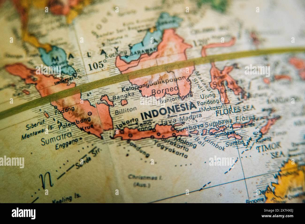 A detailed vintage antique globe showing a close-up of Indonesia, the Indonesian Islands and surrounding areas. Stock Photo