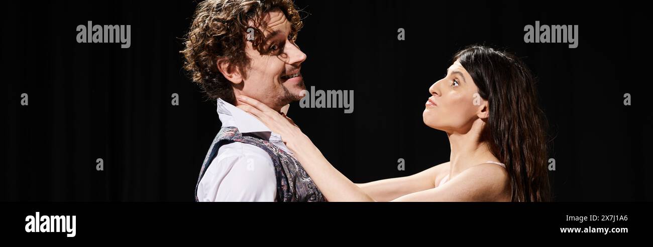 A handsome man and a beautiful woman standing close, rehearsing for a ...